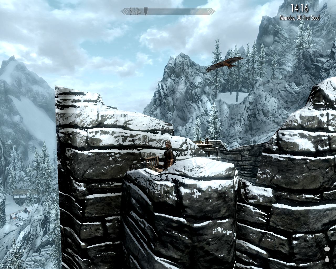 Laura stands on top of a stone citadel, a large bird flies over her head
