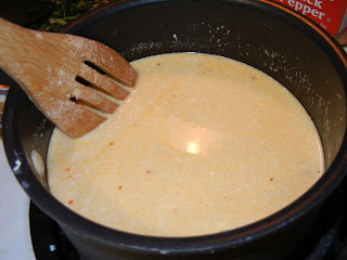 cream in a pot with a wood spoon to the left 