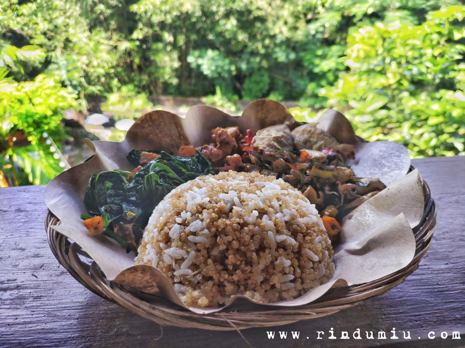 Sego Thiwul Kumplit consists of a portion of sego thiwul, vegetables, spicy stir-fried tempeh, spicy stir-fried anchovies, and gereh or common barb fish at Kopi Plosok Sego Thiwul in Sleman Jogja