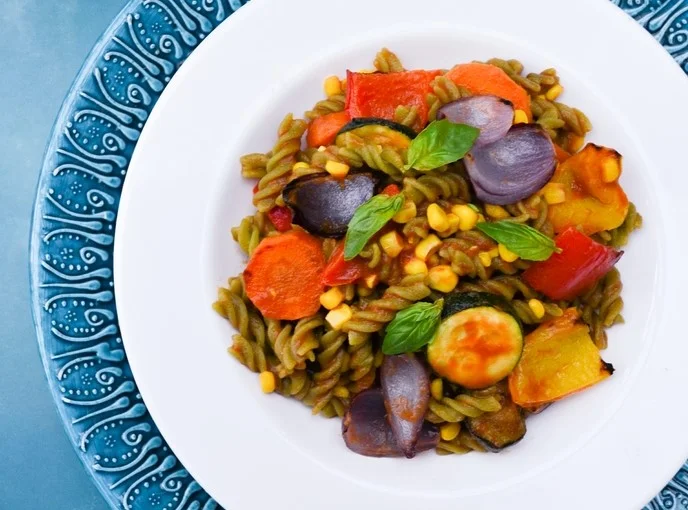A bowl of spiral pasta with roast vegetables