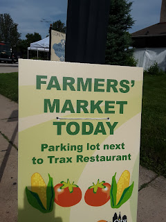 sign reading "Farmers Market Today"