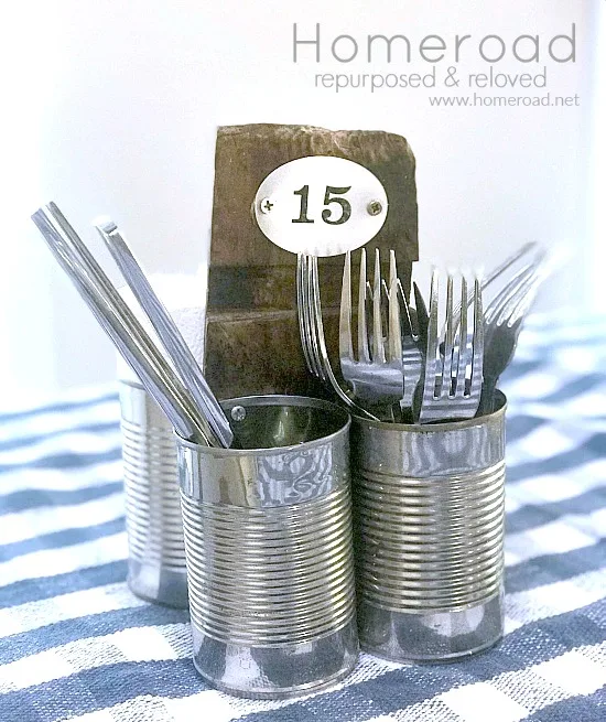 recycled cans with wooden handle and silverware