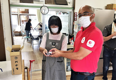 AAR's Ohara (right) hands out Toraya's yokan (sweet bean jelly) at the NPO Tsukushi no Sato Kitakata Workshop in Takeo City, Saga Prefecture, 24 August 2021.