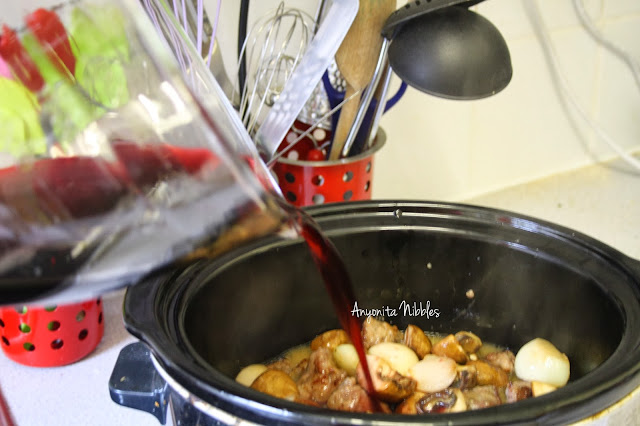 Adding wine to the slow cooker for Beef Bourguignon from www.anyonita-nibbles.com