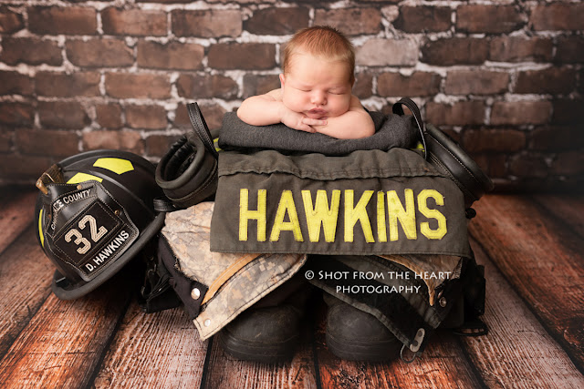 newborn baby with dads firefighter turnout gear photography 