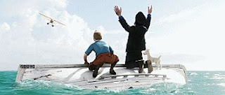 color movie still image of the rescue of shipwrecked Tintin, Captain Haddock and Snowy