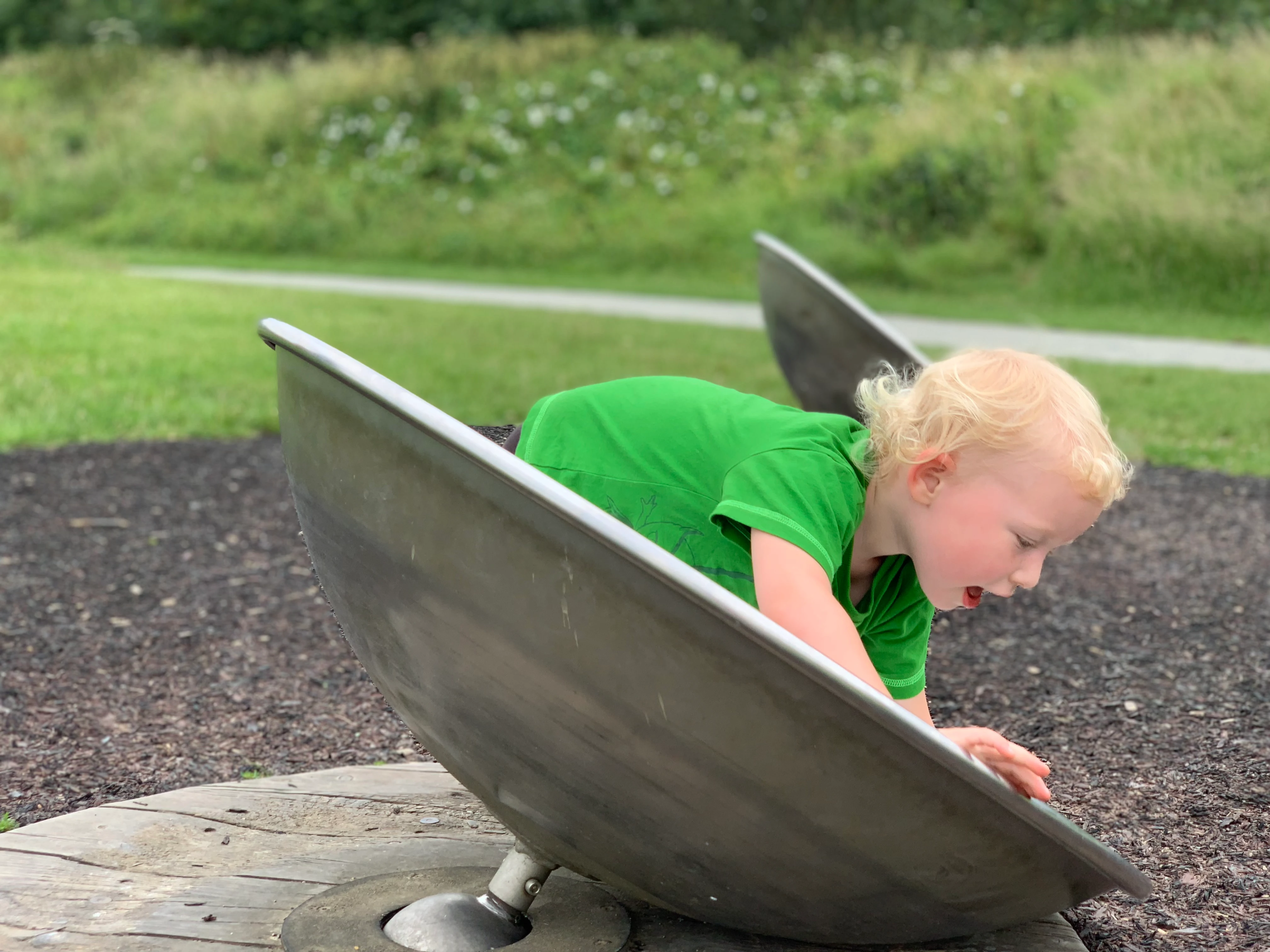 A child playing on an infinity bowl in a great playground in London and Essex