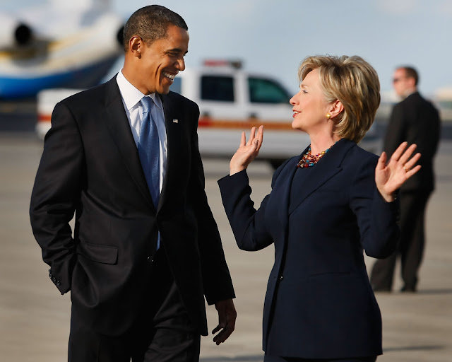 Barack Obama and Hillary Clinton walking away from his airplane as they head to a campaign rally at Amway Arena in Orlando, Florida (October 20, 2008) Photograph by Joe Raedle