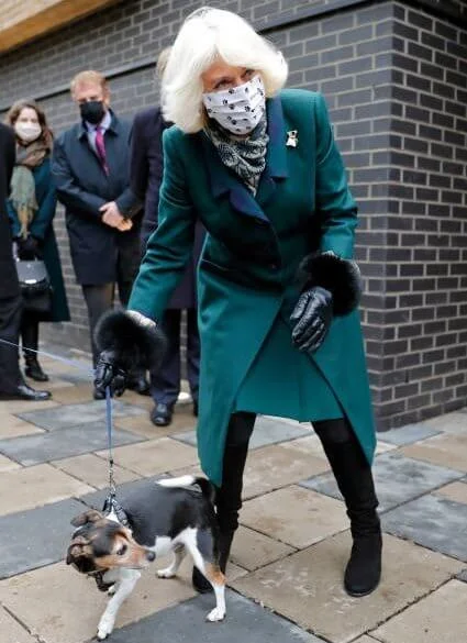 The Duchess of Cornwall is patron of the charity Battersea. Battersea introduced online puppy training classes. The Duchess wore a green wool coat