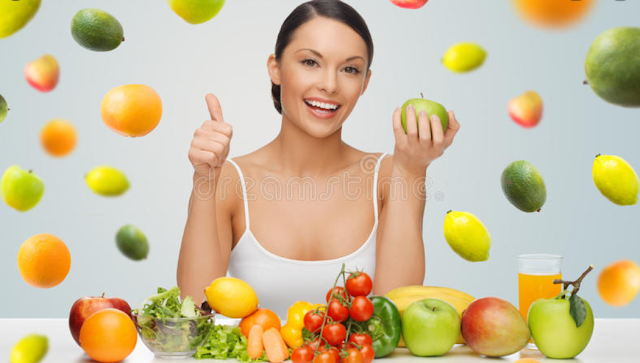 Image of smiling woman who i holding & surrounded by fruits | Kerry Loeb Self-Massage & Health Trainings