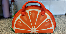 A lunch bag in the shape of an orange slice