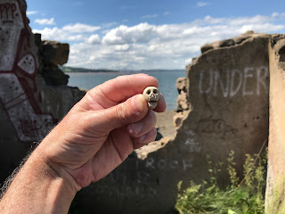 Skulferatu #37 on Cramond Island  being held up by the Duck House.  Photo by Kevin Nosferatu for the Skulferatu Project