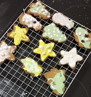 Picture of Christmas biscuits decorated with coloured icing and sprinkles on a cooling rack Picture of Christmas biscuits decorated with coloured icing and sprinkles on a cooling rack