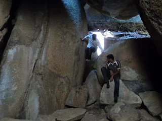 Hikers playing around the depths of the inverted trek at Siddara Betta