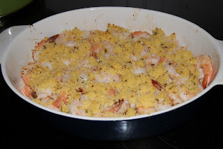 Shrimp topped with bread crumbs in a blue baking dish ready to be baked in the oven.