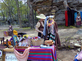 A two people wearing cultural accesories near stall of accesories