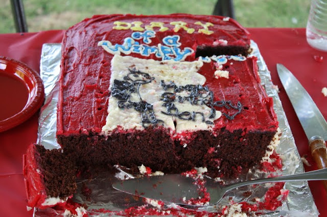 Cake with red icing, cut into slices.