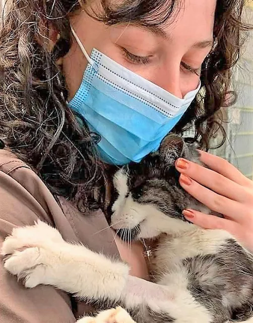 Picture of a young woman who adopted a 20-year-old cat so he wouldn't die alone
