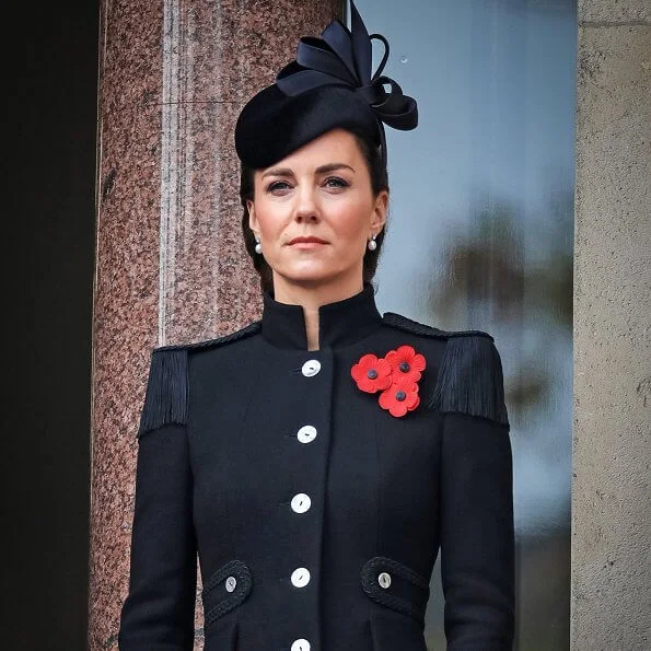 Kate Middleton wore a bespoke black military coat by Alexander McQueen, and a Philip Treacy hat. Queen's diamond and pearl earrings