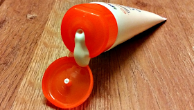 The opened tube of Calypso Sensitive Face and Neck Lotion with some of the cream dripping out of the lid.
