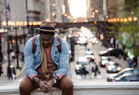 Black Man on ledge looking down Photo by whoislimos on Unsplash