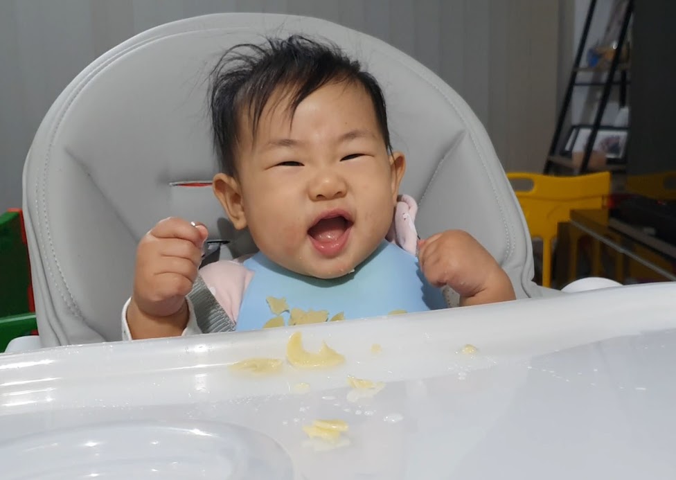 My 7-month-old happily feeding herself pasta.