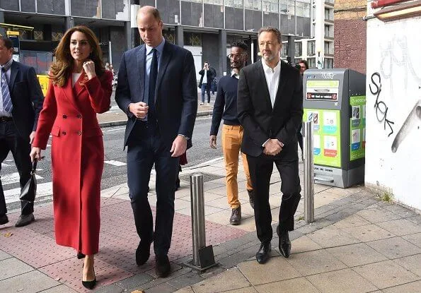 Kate Middleton was chic in a gorgeous autumnal red coat by Alexander McQueen. Grace Han Love bag. Daniella Draper luxury Maxi cupid hoops