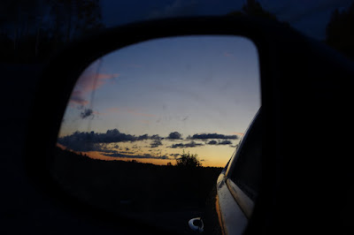 leaving sunset behind in a rear view mirror