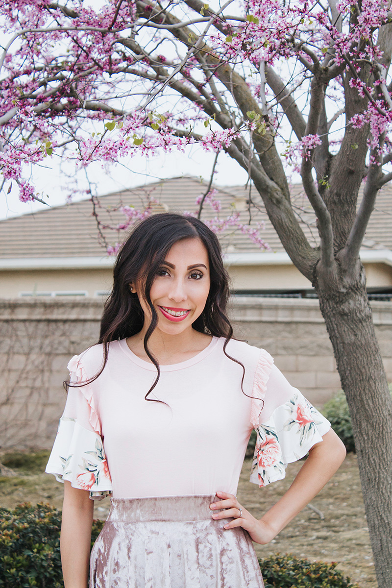 blush and floral flounce top with floral tree background