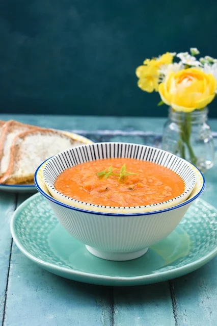 Slow cooker lentil and peanut butter soup, served with buttered brown bread