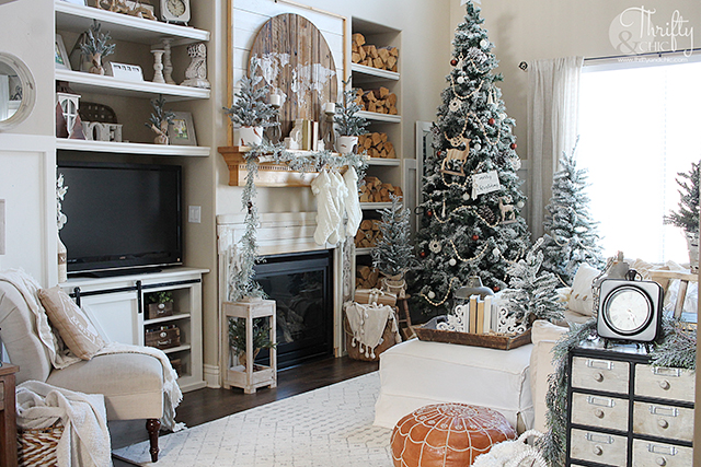 Neutral Christmas living room decor. Wood and white Christmas decor. Boho style Christmas decor. Bohemian style Christmas tree. Beaded and macrame Christmas tree decor and decorating ideas. How to decorate a Christmas tree. Farmhouse style Christmas decor. Wood and White Christmas mantel decor. Vintage Christmas mantel ideas. Flocked Christmas trees. Two story living room design.