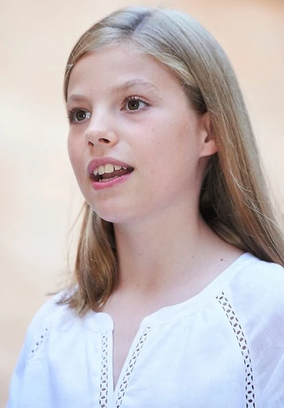 Queen Letizia wore a new white cotton dress from Dafalia collection of Hugo Boss. Princess Leonor and Infanta Sofia on holiday