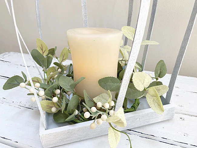 wreath and candle in base of lantern