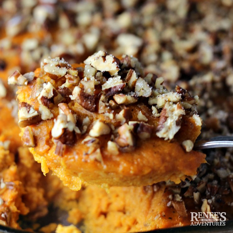 Close up of Sweet Potato Souffle Casserole by Renee's Kitchen Adventures on serving spoon with pan in background