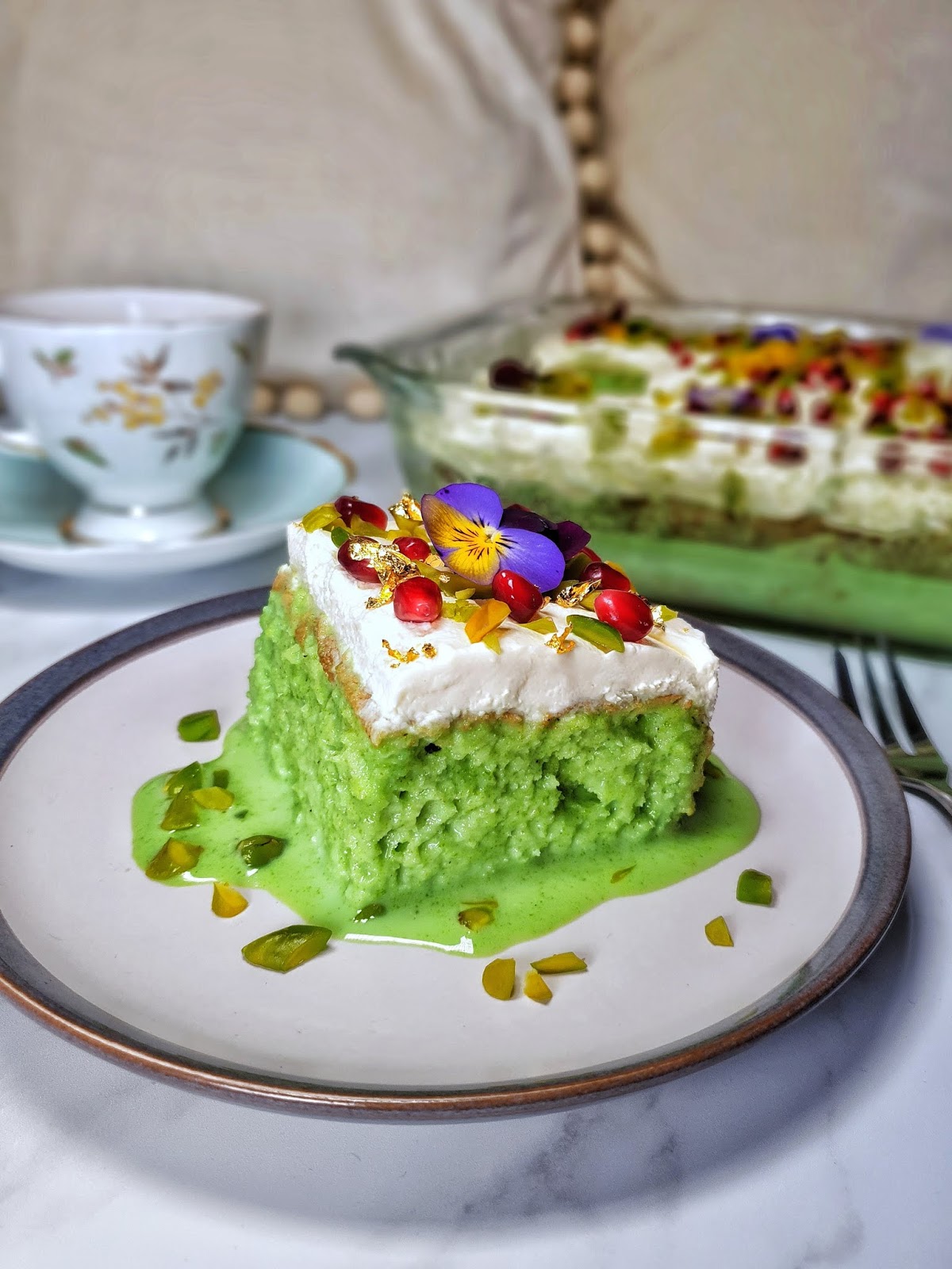Decadent tres leches cake with pistachio frosting.