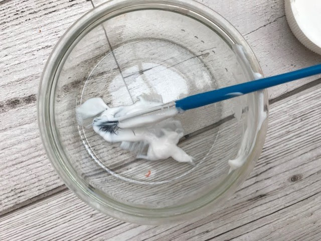 PVA glue in a dish with the paint brush
