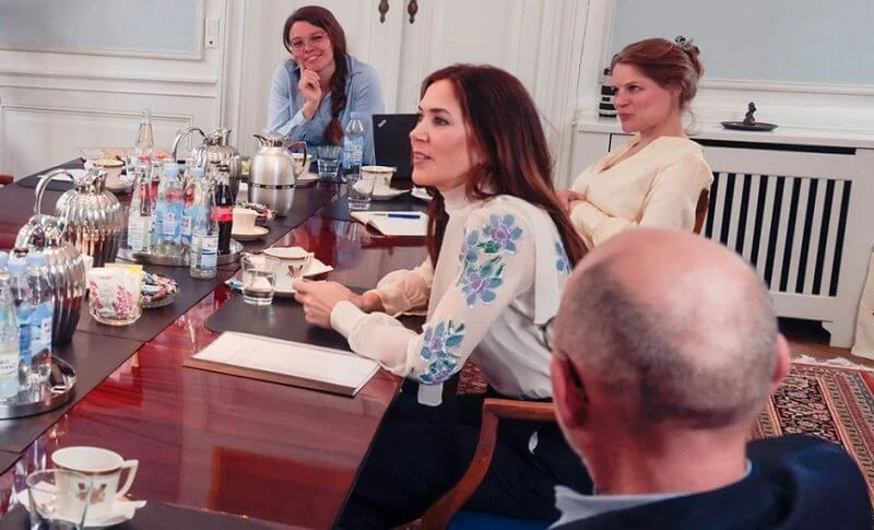 Crown Princess Mary wore a blue floral embroidered pussy bow neckline silk chiffon blouse from Prada