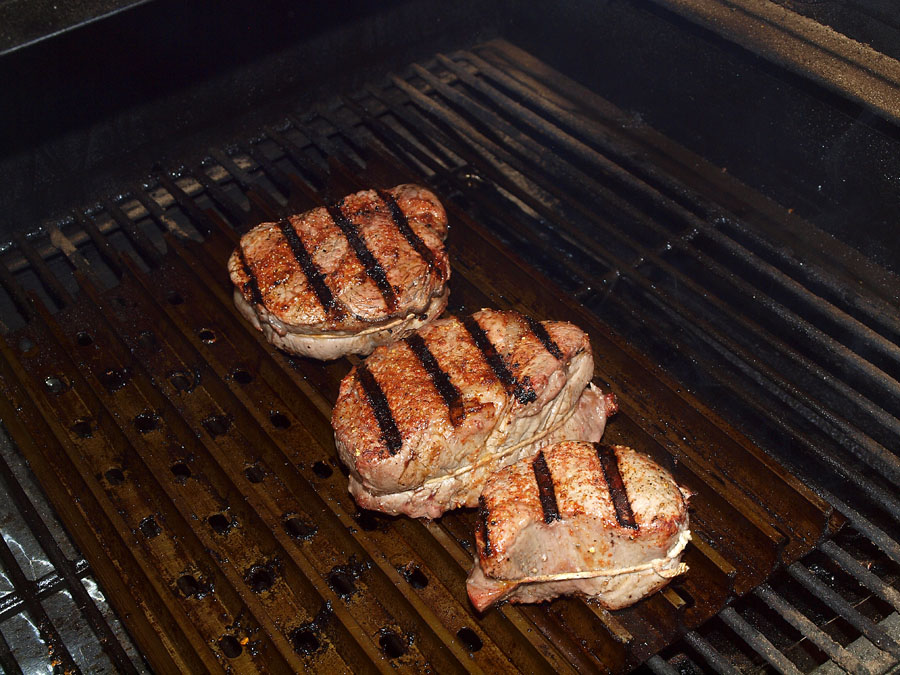 Pellet Smoker Cooking Beef Sirloin Steaks and Baked Potatoes