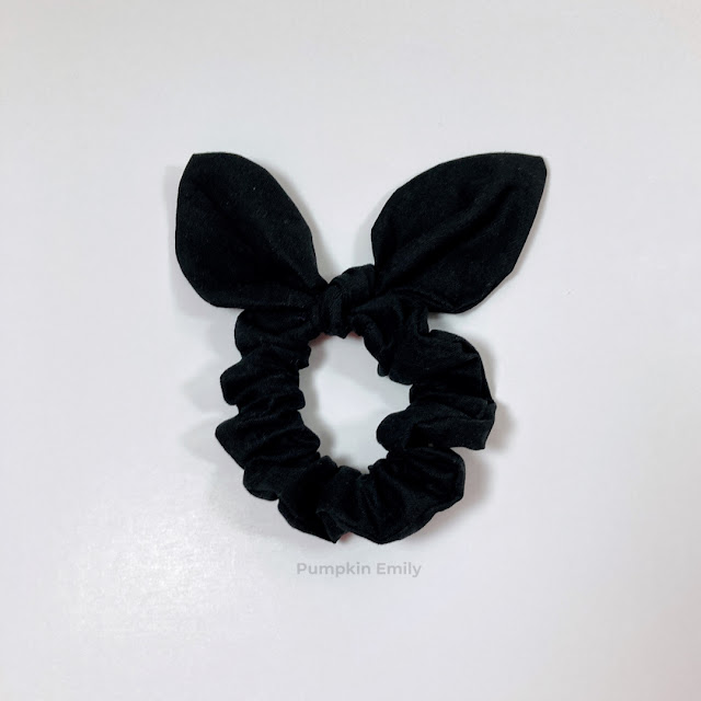 A black bunny ear scrunchie.