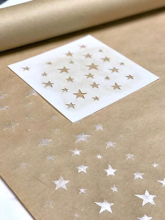 stenciled stars and stencil on brown paper