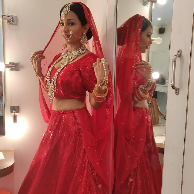 Hot actress ASHA SAINI (Flora Saini) stills in red color lehenga choli