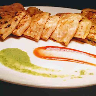 Serving aloo paratha with green chutney and tomato sauce for aloo paratha recipe