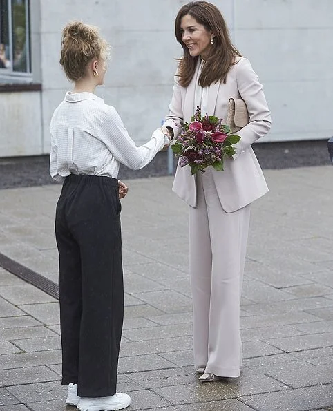 Crown Princess Mary wore Andiata Cecel blazer and Gytta trousers and Gianvito Rossi python pumps. Naledi Copenhagen clutch