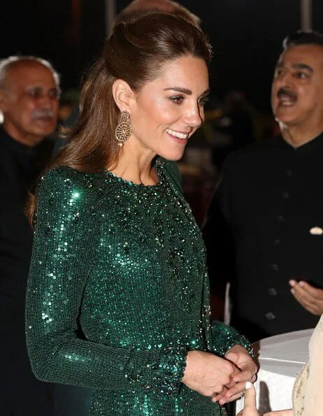 Kate Middleton wore a sparkling emerald green gown by Jenny Packham, and earrings by O'nita. Prince William wore a traditional Sherwani by Naushemian