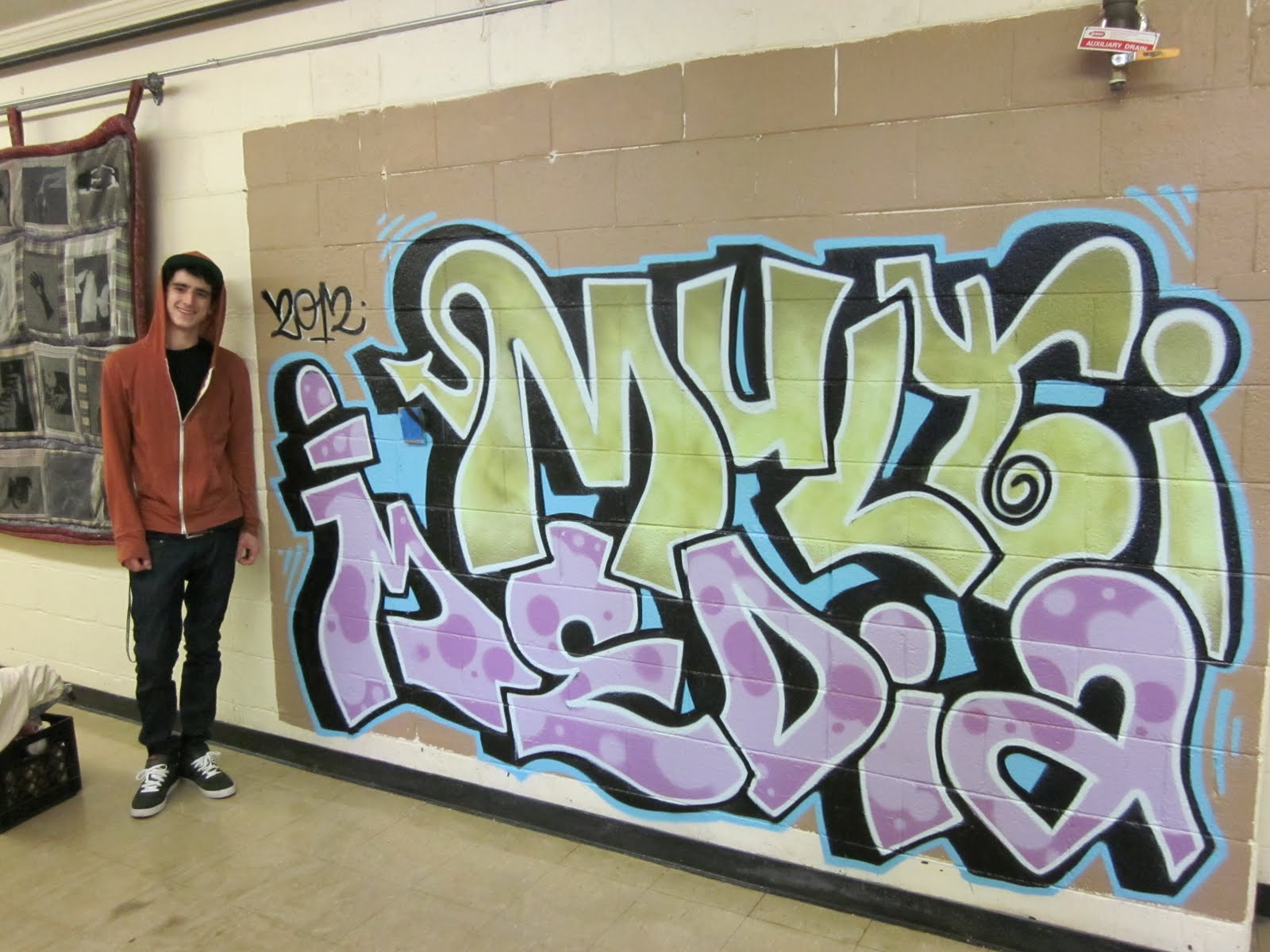 AAW 2D ART AAW student paints graffiti mural in our hallway
