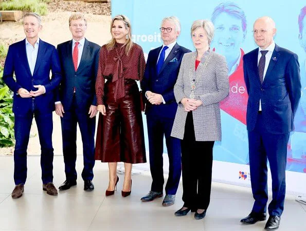 Queen Maxima wore Zara Polka dot blouse with bow detail, and burgundy ankle length wide leg high waisted leather trousers