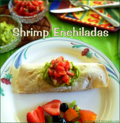 Shrimp Enchiladas feature large and small shrimp, spicy cheese and rice rolled into a soft tortilla and baked.  | Recipe developed by www.BakingInATornado.com | #recipe #dinner