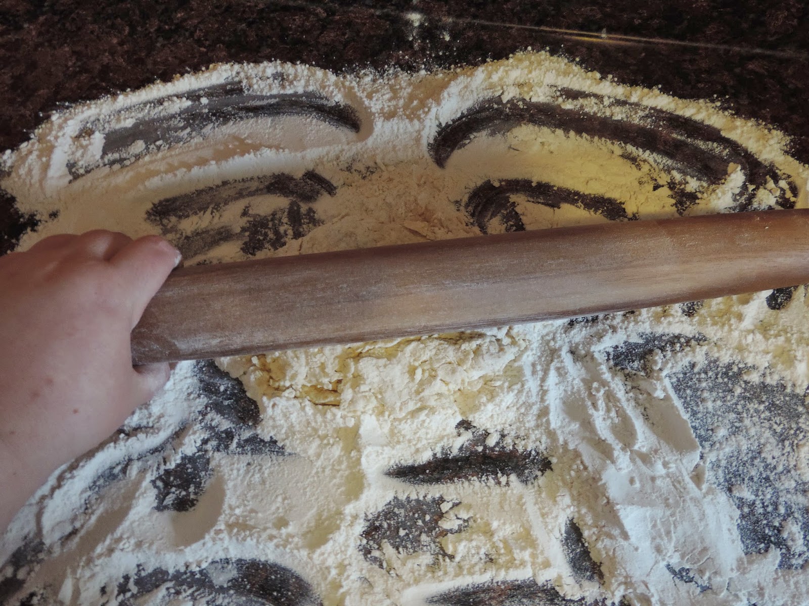 The homemade noodle dough being rolled out on the floured surface. 