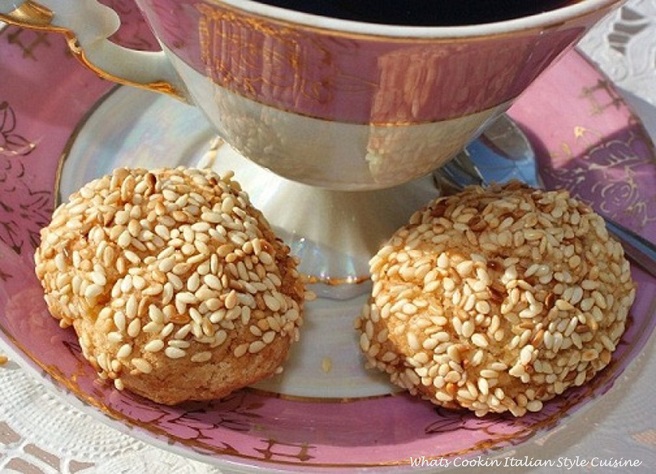 these are cookies on a dollie with espresso, a espresso spoon and sesame seed Italian cookies