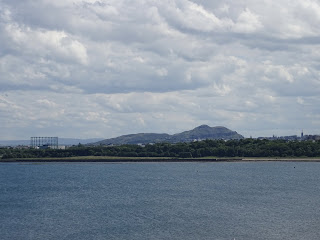 View over to A view over the sea from Cramond Island to Granton gasworks with Arthur’s Seat and Edinburgh in the background.  Photo by Kevin Nosferatu for the Skulferatu Project